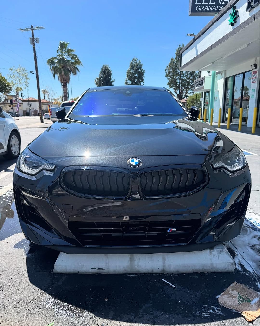 Dark sedan, front, after a wash and exterior detail