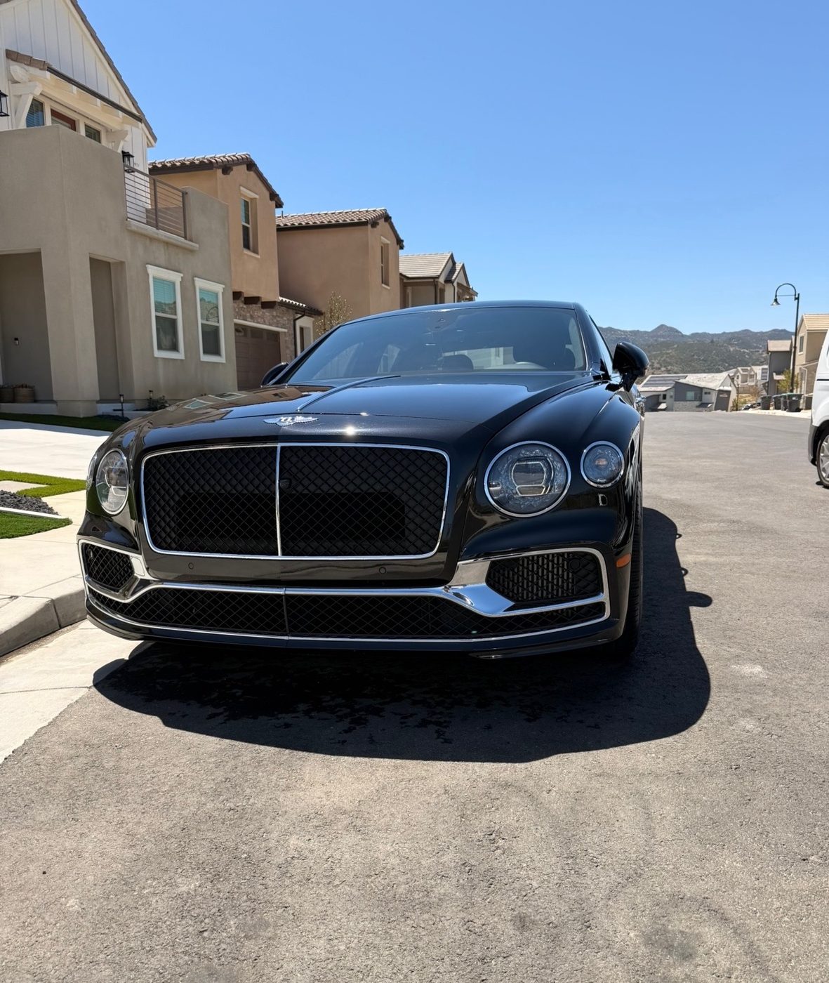 Black sports car with a deep-gloss finish after a full detail